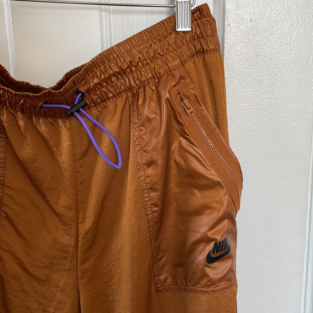 Nike gold nylon joggers with purple bungee cord